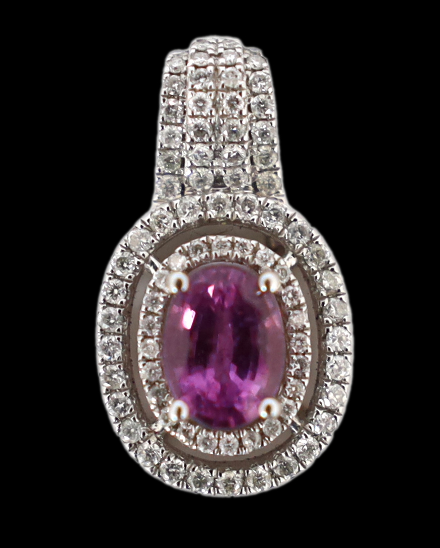 A modern 14ct white gold, pink sapphire and diamond set oval cluster pendant